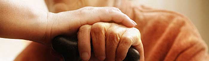 Photo of Elderly Woman's Hands Holding Cane