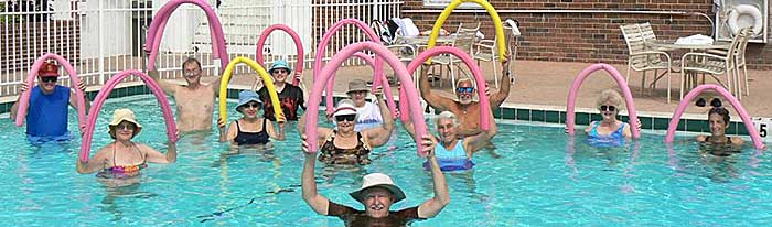 Photo of Elderly People in Pool with Noodles